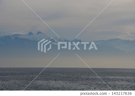 Mountains on the opposite shore of Lake Geneva shrouded in mist, as seen from Lausanne, Switzerland (January 3, 2020) Mountains on the opposite shore of Lake Geneva shrouded in mist, as seen from Lausanne, Switzerland (January 3, 2020) 143217636