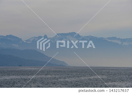 Mountains on the opposite shore of Lake Geneva shrouded in mist, as seen from Lausanne, Switzerland (January 3, 2020) Mountains on the opposite shore of Lake Geneva shrouded in mist, as seen from Lausanne, Switzerland (January 3, 2020) 143217637