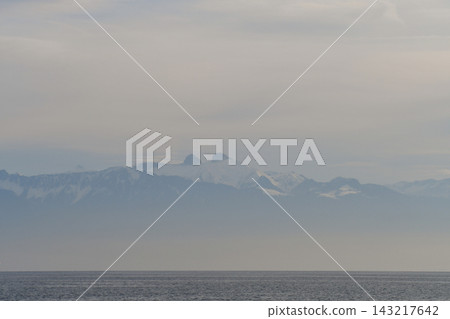 Mountains on the opposite shore of Lake Geneva shrouded in mist, as seen from Lausanne, Switzerland (January 3, 2020) Mountains on the opposite shore of Lake Geneva shrouded in mist, as seen from Lausanne, Switzerland (January 3, 2020) 143217642