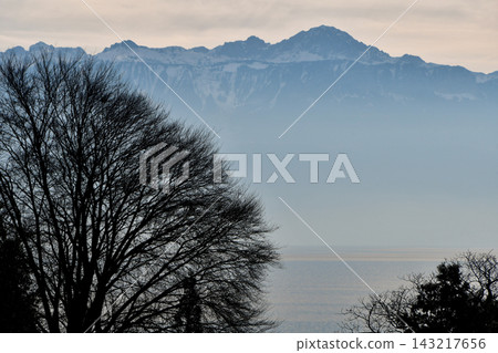 Mountains on the opposite shore of Lake Geneva shrouded in mist, as seen from Lausanne, Switzerland (January 3, 2020) Mountains on the opposite shore of Lake Geneva shrouded in mist, as seen from Lausanne, Switzerland (January 3, 2020) 143217656