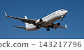 The plane lands, passenger airliner. The plane lands. Airplane, passengers flying in the blue sky, preparing to land at the airport 143217796