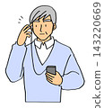 An elderly man listening with earphones 143220669