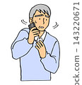 An elderly man is flustered by the phone call. 143220671