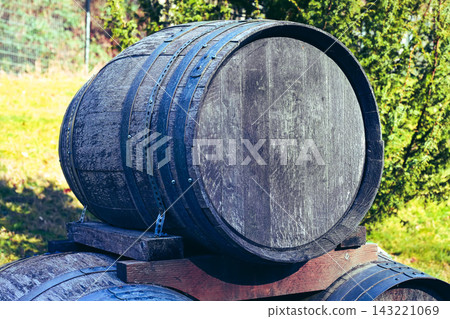 A group of old wooden barrels stacked on a wooden pallet. A group of old wooden barrels stacked on a wooden pallet. 143221069