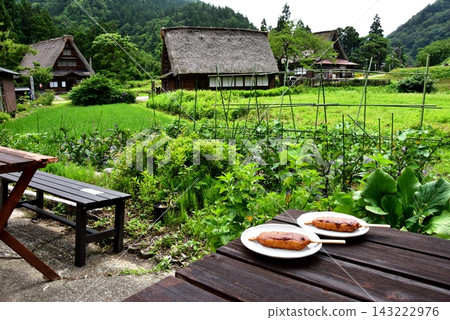Rural scenery, rest area, and Goheimochi (rice cakes) in the Gokayama Suganuma Gassho-zukuri village in Nanto City, Toyama Prefecture. Rural scenery, rest area, and Goheimochi (rice cakes) in the Gokayama Suganuma Gassho-zukuri village in Nanto City, Toyama Prefecture. 143222976