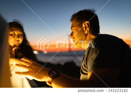 Couple having intimate conversation at twilight near bosphorus bridge Couple having intimate conversation at twilight near bosphorus bridge 143223182