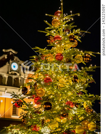 A scene featuring a colorful Christmas tree adorned with illuminations. A scene featuring a colorful Christmas tree adorned with illuminations. 143225097