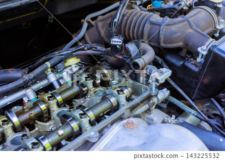 Mechanic is working on engine of car is on camshaft, valve assembly. Mechanic is working on engine of car is on camshaft, valve assembly. 143225532