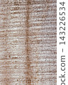 Aged wooden plank surface featuring a natural texture with grooves providing a rustic and worn background element. 143226534