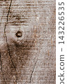 Aged wood texture background with natural cracks and knot, showcasing weathered rustic surface detail and abstract pattern for design element 143226535