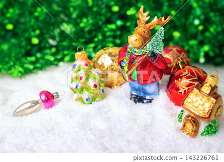 New Year's background with Christmas tree decorations, New Year's glass deer on a Christmas tree, place for text New Year's background with Christmas tree decorations, New Year's glass deer on a Christmas tree, place for text 143226761