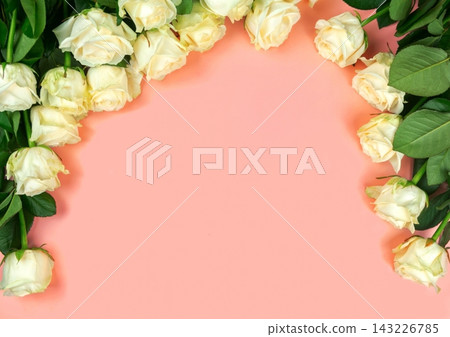 beautiful white roses on a light red background. place for text. top view background beautiful white roses on a light red background. place for text. top view background 143226785