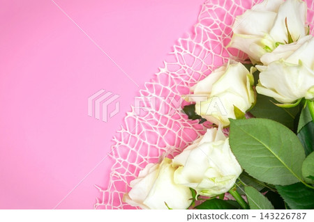 beautiful white roses on a pink background. place for text. top view background beautiful white roses on a pink background. place for text. top view background 143226787