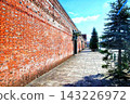 A road leading to a red brick warehouse 143226972