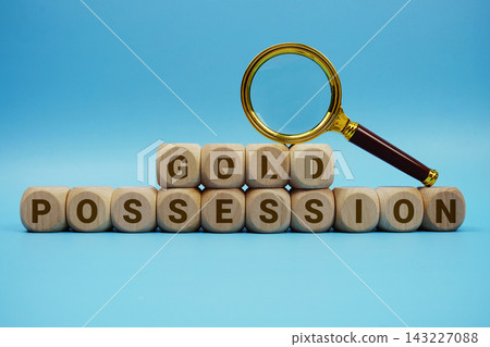Gold Possession alphabet letters wooden cube and magnifying glass on blue background Gold Possession alphabet letters wooden cube and magnifying glass on blue background 143227088