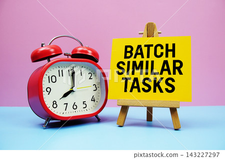 Batch Similar Tasks text with alarm clock on pink and blue background Batch Similar Tasks text with alarm clock on pink and blue background 143227297
