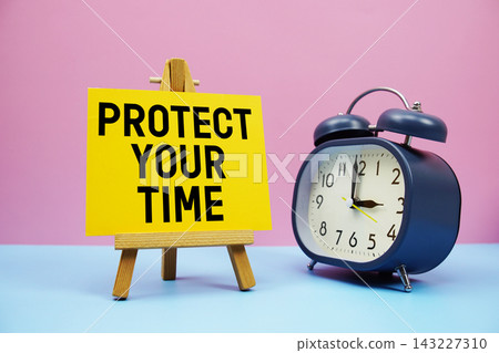Protect Your Time text with alarm clock on pink and blue background Protect Your Time text with alarm clock on pink and blue background 143227310