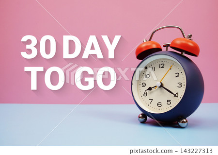 30 Day to go text with alarm clock on pink and blue background 30 Day to go text with alarm clock on pink and blue background 143227313