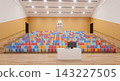 3D render of an empty auditorium with orange walls, wooden floor, tiered colorful seating, and a desk with a monitor. 143227505