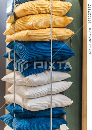 Stacked Ribbed Cushions in Yellow, Blue, and White 143227577