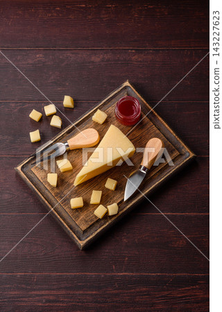 Hard aged Parmesan cheese in blocks and cubes for home cooking. Parmesan cheese Hard aged Parmesan cheese in blocks and cubes for home cooking. Parmesan cheese 143227623