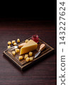Hard aged Parmesan cheese in blocks and cubes for home cooking. Parmesan cheese 143227624