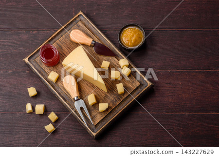 Hard aged Parmesan cheese in blocks and cubes for home cooking. Parmesan cheese Hard aged Parmesan cheese in blocks and cubes for home cooking. Parmesan cheese 143227629