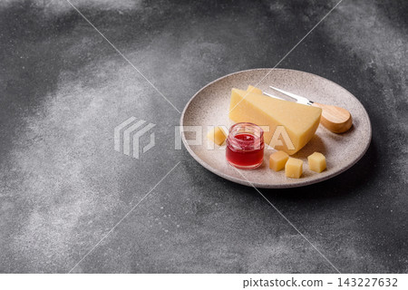 Hard aged Parmesan cheese in blocks and cubes for home cooking. Parmesan cheese Hard aged Parmesan cheese in blocks and cubes for home cooking. Parmesan cheese 143227632