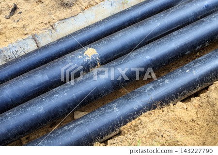 Long-distance district heating pipeline in a trench. Installation of district heating networks Long-distance district heating pipeline in a trench. Installation of district heating networks 143227790