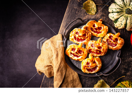 Halloween mini pies in shape of pumpkin Jack-o-lantern Halloween mini pies in shape of pumpkin Jack-o-lantern 143227857