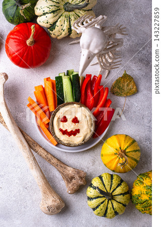 Halloween healthy snack Hummus in shape on pumpkin jack-o-lanter Halloween healthy snack Hummus in shape on pumpkin jack-o-lanter 143227859