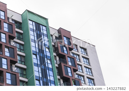 Modern residential apartment building with blue and turquoise facade panels. Urban Modern residential apartment building with blue and turquoise facade panels. Urban 143227882