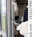Manual adjustment of a new window in a newly built apartment. 143227998