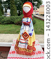 Slavic folk doll. Traditional Eastern European folk costume on a mannequin outdoors 143228003