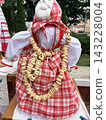Folklore. Traditional baranki, ring-shaped rolls, set against a folk costume featuring an embroidered apron. 143228004