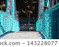 Turquoise Suspension Bridge Covered With Love Locks 143228077