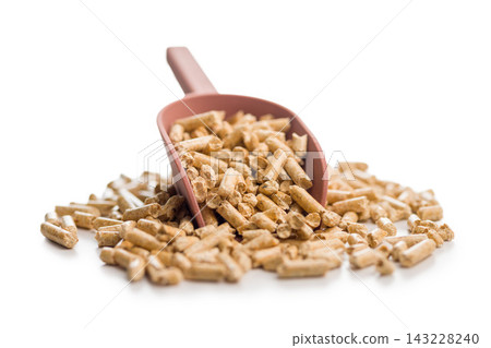Wood Pellet Fuel Pile With Red Scoop Close-Up Biomass Heating Pellets For Stove And Boiler Wood Pellet Fuel Pile With Red Scoop Close-Up Biomass Heating Pellets For Stove And Boiler 143228240