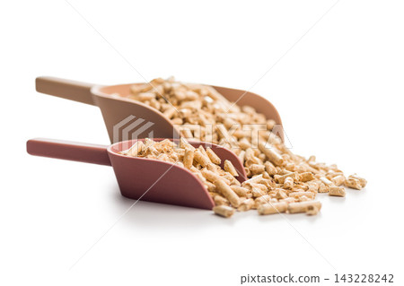 Wood Pellet Fuel Pile With Red Scoop Close-Up Biomass Heating Pellets For Stove And Boiler Wood Pellet Fuel Pile With Red Scoop Close-Up Biomass Heating Pellets For Stove And Boiler 143228242