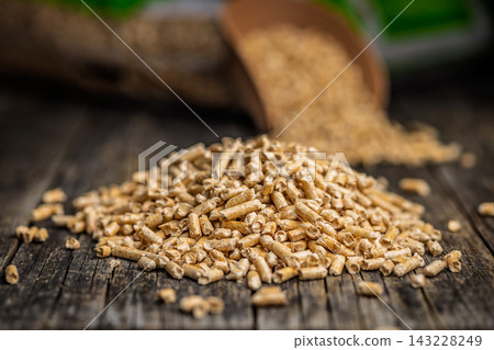 Scoop of Wood Pellets Spilling From Bag for Heating Fuel and Sustainable Biomass Energy Scoop of Wood Pellets Spilling From Bag for Heating Fuel and Sustainable Biomass Energy 143228249