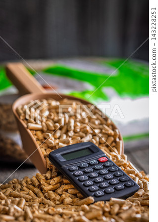 Wood Pellets And Calculator On Table Representing Biofuel Heating Costs And Renewable Energy Budgeting Wood Pellets And Calculator On Table Representing Biofuel Heating Costs And Renewable Energy Budgeting 143228251
