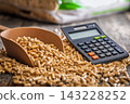 Wood Pellets And Calculator On Table Representing Biofuel Heating Costs And Renewable Energy Budgeting 143228252