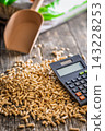 Wood Pellets And Calculator On Table Representing Biofuel Heating Costs And Renewable Energy Budgeting 143228253