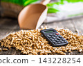 Wood Pellets And Calculator On Table Representing Biofuel Heating Costs And Renewable Energy Budgeting 143228254