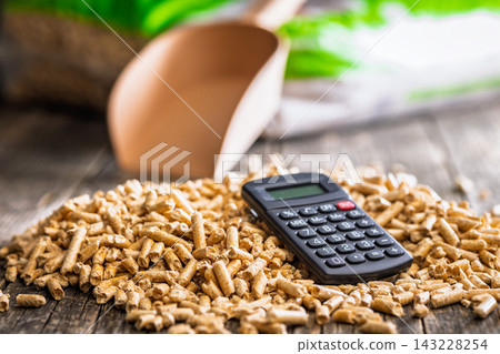 Wood Pellets And Calculator On Table Representing Biofuel Heating Costs And Renewable Energy Budgeting Wood Pellets And Calculator On Table Representing Biofuel Heating Costs And Renewable Energy Budgeting 143228254