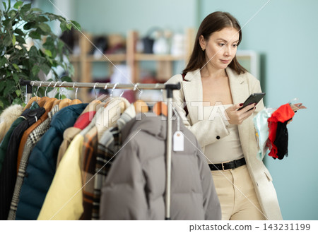 Young woman scans qr code of panties in store 143231199