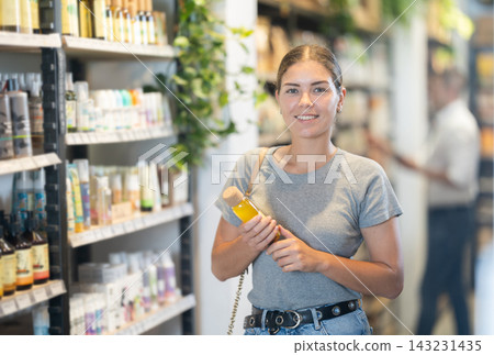 Young woman selecting natural beauty products in eco store Young woman selecting natural beauty products in eco store 143231435