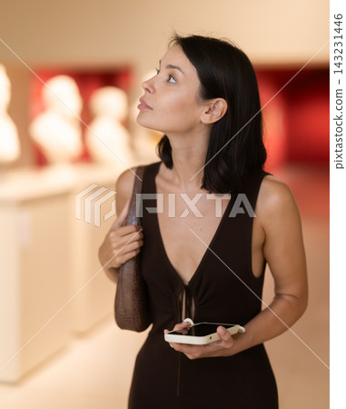 Brunette visits the halls of the museum with interest Brunette visits the halls of the museum with interest 143231446