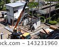 身穿空調工作服的建築工人和鷹架工人在建築工地搭建臨時辦公室。 143231960