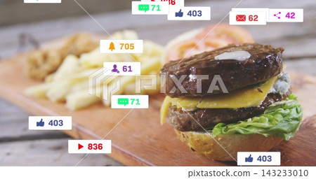 Showing double cheeseburger sitting on wood board, with fries and social badges, copy space 143233010