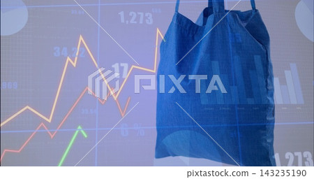 Hanging blue canvas tote bag with creased straps studio showing finance charts and data, copy space Hanging blue canvas tote bag with creased straps studio showing finance charts and data, copy space 143235190